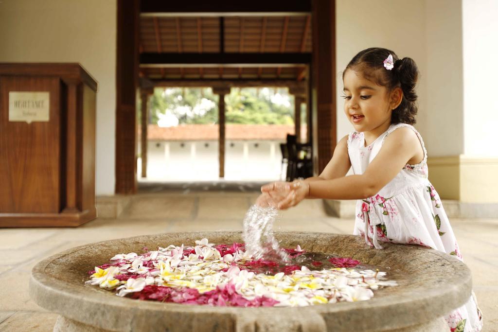 Heritage Madurai Ngoại thất bức ảnh A girl playing with flowers